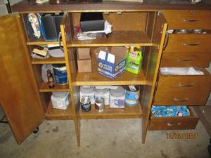 Large Vintage 7-drawer 3-door wood storage cabinet with content including a variety of household maintenance hardware and supplies, paints, cleaners and more. measures approximately 60.51549
