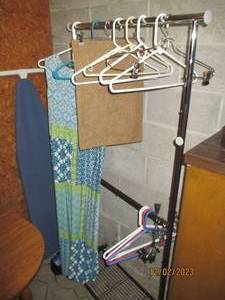 2-tier metal framed rolling wardrobe rack, ironing board hangers and other content