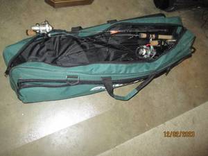 Soft sided Guide Series Fishing bag with content to include ice fishing poles and supplies