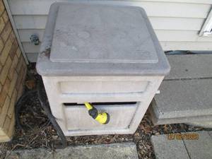 Outdoor covered hose reel container with hose and sprayer