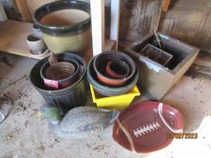 Outdoor planters grouping along with a mallard decoy and football shaped serving platter