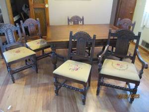 Vintage farmhouse style table and 6 chairs. While all chairs have a floral embroidered seat, only one is a captains, reserved for the head of the table.