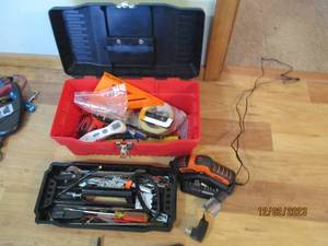 Red and black plastic household toolbox, magnetic Milwaukee 25 measuring tape along with other Misc hand tools and supplies