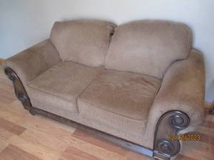Oversized 2-cushion Brown Upholstered loveseat with dark wood trim and accents