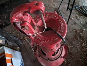 Antique pump mounted on a milk can...