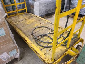 Large wooden and steel rolling cart in yellow