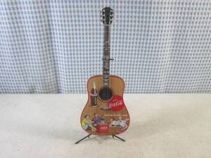 lot 251 image: (BS) Coca-Cola A Song and A Smile Guitar Collection Feel Good Refreshment with Stand