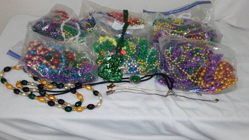 lot 524 image: Mardi Gras Beads, Marbles and small toys.