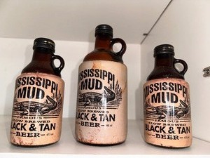 lot 206 image: Mississippi Mud Black and Tan Vintage Beer Bottles