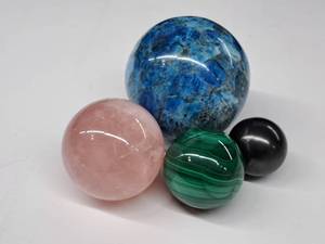 lot 59 image: Display Gem #9 Four polished spheres of various size. Apatite, Malachite, Rose quartz and Shungite
