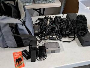lot 241 image: Camera Bag with Misc. Microphone Accessories, Canon Dual Battery Charger, Sony Codec Converter, Wireless Microphone Transmitter