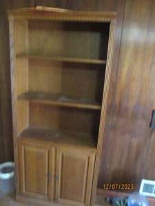 lot 34 image: Tall wood 3-tier bookshelf with lower storage