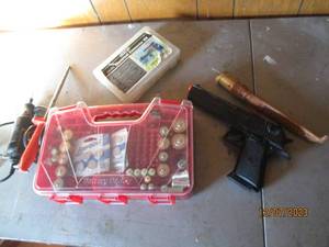 lot 51 image: Battery caddy with an assortment of batteries, knife sharpener, filet knife, Dremel, air soft type hand gun and more