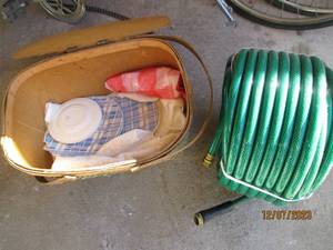 lot 14 image: Vintage picnic basket with misc dishes along with a new 100 medium duty garden hose