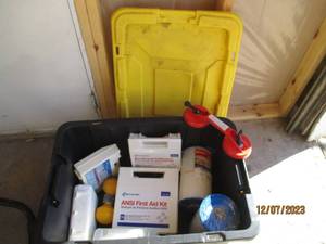 lot 28 image: Large covered tote full of 1st aid kits, pool filters, suction handles for glass or dent pullers