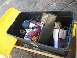 lot 63 image: 50-gallon covered tote full of camping and household supplies