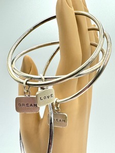 lot 181 image: Four Sterling Silver Charm Bracelets