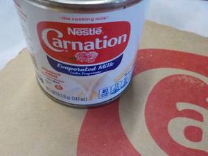 lot 118 image: 24 ct 5 oz Cans Nestles Carnation Evaporated Milk - best date 08312023