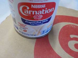 lot 119 image: 24 ct 5 oz Cans Nestles Carnation Evaporated Milk - best date 08312023