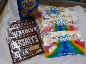 lot 140 image: 1 Box Honey Maid Graham Crackers, 4 bags Jet Puffed Marshmallows and 3 - 6 packs Full Size Candy Bars