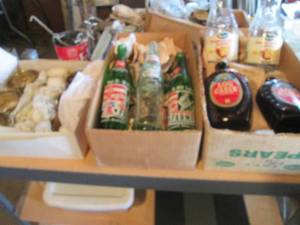 lot 102 image: Vintage Advertisement soda bottles, amber glass syrup bottles and other Misc housewares
