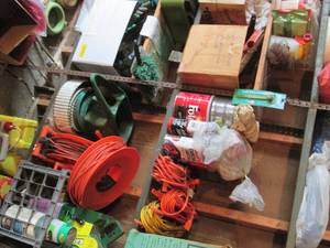 lot 152 image: All content on shelves to include a large variety of gardening supplies, shop rags, extension cords with other outdoor tools and supplies (shelves not included)