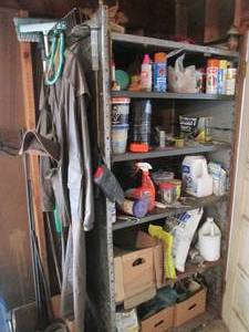 lot 155 image: All content on shelf consisting of assorted outdoor chemicals and sprays, vintage trench coat, fishing hat, window Squeegee and brush plus more