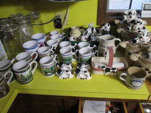 lot 218 image: Large variety of Cow themed kitchen supplies and decor from table helpers to countertop storage