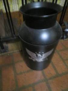 lot 32 image: Vintage plastic painted milk can with eagle sprayed design