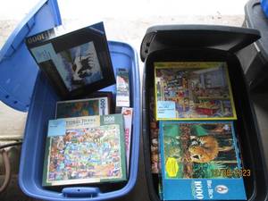 lot 53 image: (2) Covered Storage Totes filled with a nice assortment of jigsaw puzzles in a variety of difficulty levels. (If any pieced were to be missing, it seems to be noted)