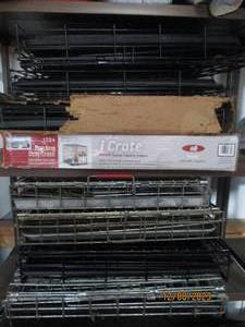 lot 64 image: Stack of (8) assorted size metal pet crates to contain your furry friends or scrap for cash
