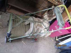 lot 69 image: Super cute Pet containment stroller with an open netted section and a covered house style compartment.