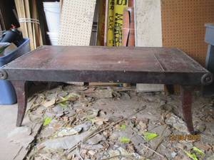 lot 90 image: Vintage Wood coffee table with decorative scrolled edges and markings