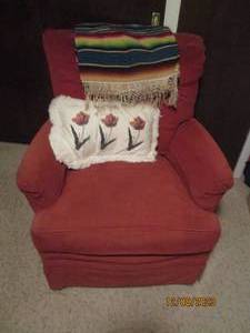 lot 258 image: Dark rust tone padded and Upholstered vintage rocking chair with accent pillow and Navajo style accent tapestry