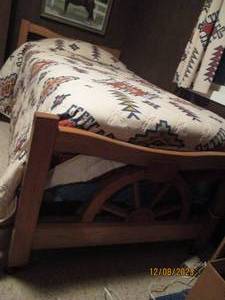 lot 261 image: 5pc Rustic Country Wagon Wheel style wood bedroom set with 4-drawer highboy dresser, 4-drawer student style desk, chair, and bed frame with head and foot boards.