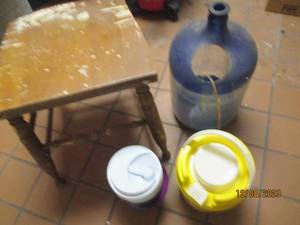 lot 13 image: Vintage Wood chair base, insulated Thermometer and large glass carboy turned aquarium