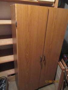 lot 28 image: Wood style 2-door pantry cabinet with 3-tiers of interior storage space
