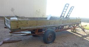 lot 231 image: A pontoon trailer used to pull the boat out of the water, currently a raised garden on wheels