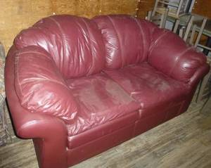 lot 323 image: Maroon leather (or leather-like) sofa