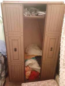 lot 107 image: Cardboardmetal wardrobe with comforters, sheets, sleeping bag and more