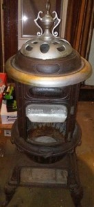 lot 798 image: Cast Wood Stove With Finial.