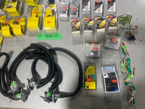 lot 56 image: TABLE FULL OF 7 TO 6 ADAPTERS, TRAILER WIRING PLUGS, PULSE PREVENTORS, WIRING HARNESS