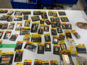 lot 16 image: TABLE FULL OF STANLEY HINGES, CHEST LATCHES, CORNERS, SURFACE BOLT, & FLAT BRACES
