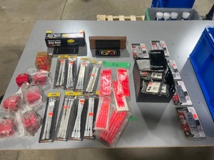 lot 52 image: TABLE FULL OF TRAILER SEALS, LOCKS, MAP LIGHTS ETC