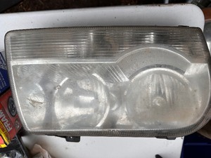 lot 56 image: Headlight Assembly #9006 - States it is for Chrysler 300