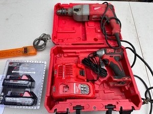 lot 75 image: Milwaukee Heavy Duty Corded Drill and Impact Driver, includes 2 new in packaging batteries.