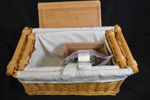 lot 193 image: Fabric Lined Wicker Baskets with Poo-Pourri and Cutting Board