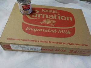 lot 153 image: 24 ct 5 oz Cans Nestles Carnation Evaporated Milk - best date 08312023