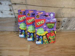 lot 25 image: THREE (3) Teenage Mutant Ninja Turtles Mutant Mayhem UNO Card Games
