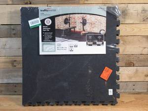 lot 97 image: TrafficMaster Black with Blue Flecks 25.2 in. x 25.2 in. x 0.68 in. Foam Shock Absorbing Gym Floor Tiles(4 TilesPack) (17.64 sq. ft.)